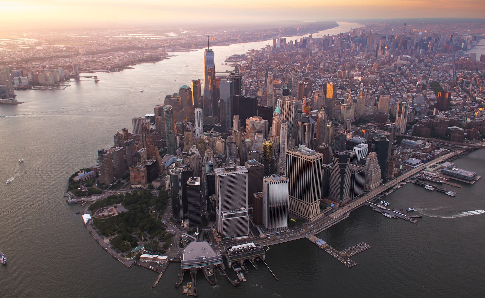 Glass office towers in a financial district skyline, representing the concentration of AI-driven fraud risk in Caribbean banking and insurance